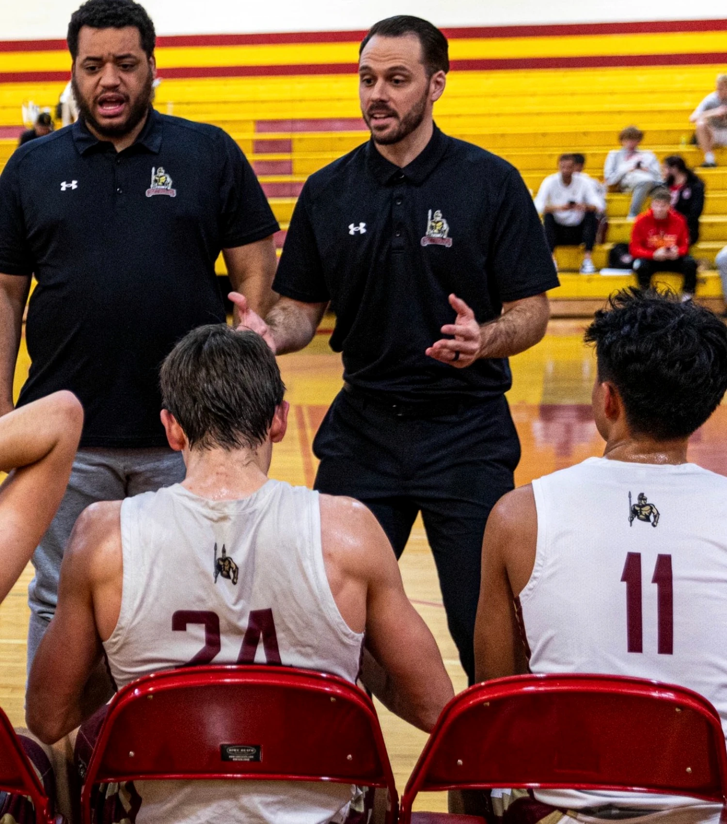 Coach Hood speaking to players during a timeout